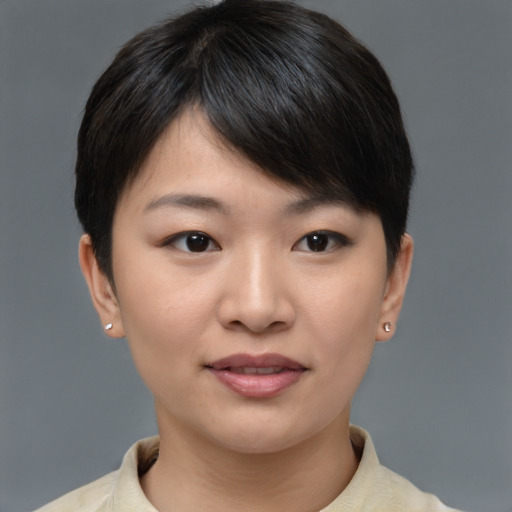 Joyful asian young-adult female with short  brown hair and brown eyes