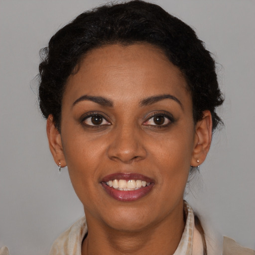 Joyful black young-adult female with medium  brown hair and brown eyes