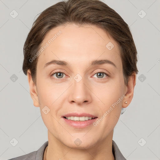 Joyful white young-adult female with short  brown hair and grey eyes