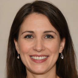 Joyful white adult female with long  brown hair and brown eyes