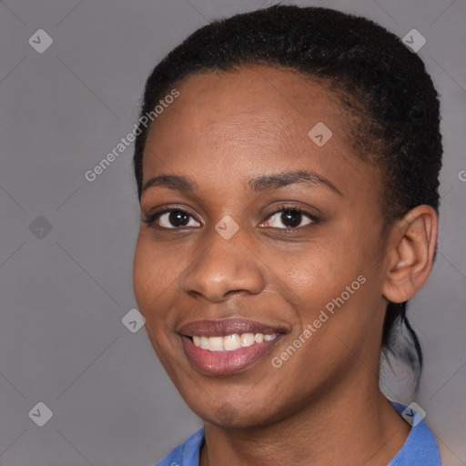 Joyful black young-adult female with short  black hair and brown eyes