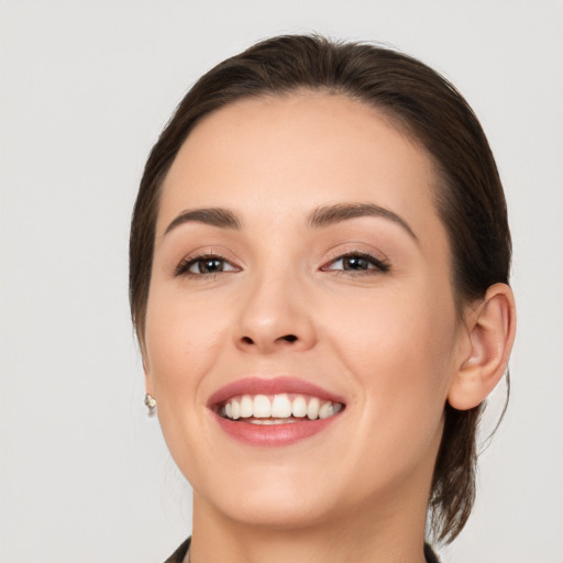 Joyful white young-adult female with medium  brown hair and brown eyes