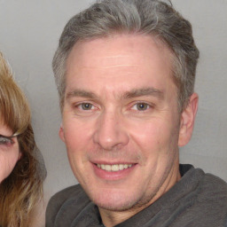 Joyful white adult male with short  brown hair and grey eyes