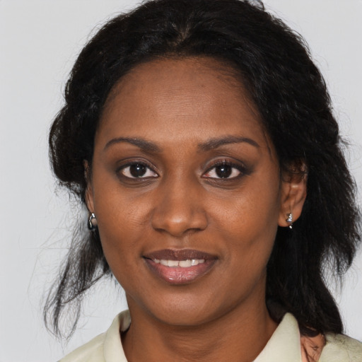 Joyful black young-adult female with medium  brown hair and brown eyes