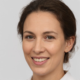 Joyful white adult female with medium  brown hair and brown eyes