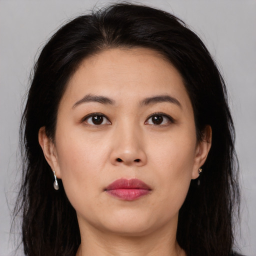 Joyful asian young-adult female with long  brown hair and brown eyes