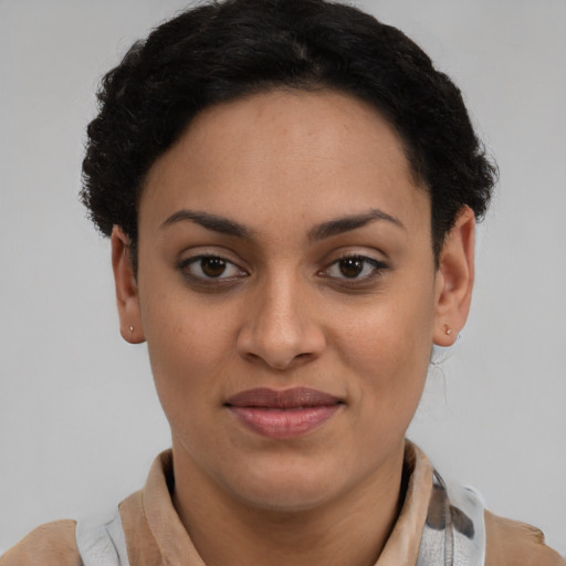 Joyful latino young-adult female with short  brown hair and brown eyes