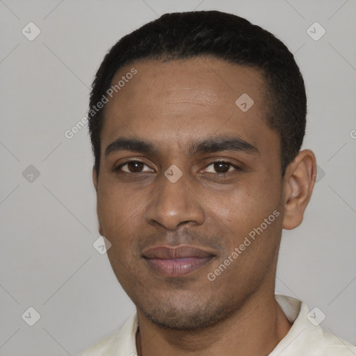 Joyful black young-adult male with short  black hair and brown eyes