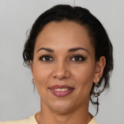 Joyful latino adult female with medium  brown hair and brown eyes