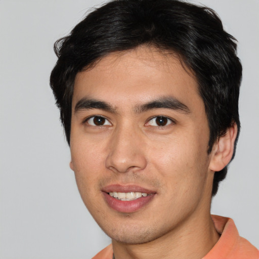 Joyful asian young-adult male with short  brown hair and brown eyes
