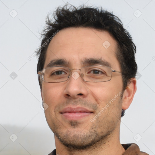 Joyful white adult male with short  black hair and brown eyes