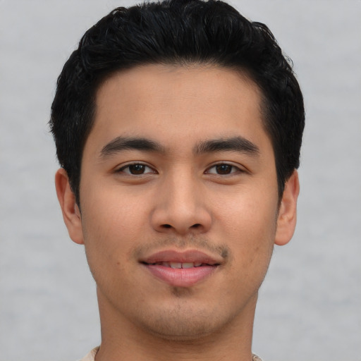 Joyful asian young-adult male with short  black hair and brown eyes