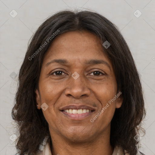 Joyful latino adult female with medium  brown hair and brown eyes