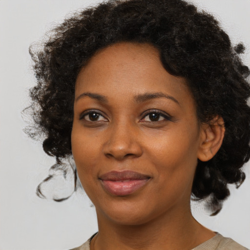Joyful black young-adult female with medium  brown hair and brown eyes