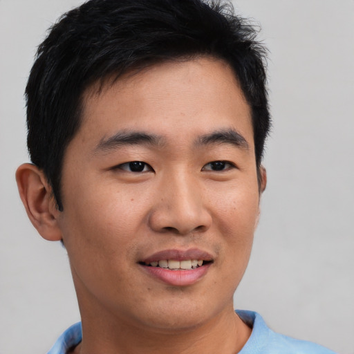 Joyful asian young-adult male with short  brown hair and brown eyes
