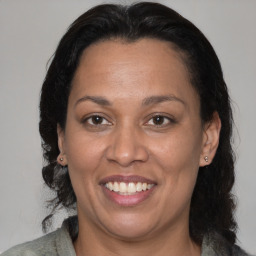 Joyful black adult female with medium  brown hair and brown eyes