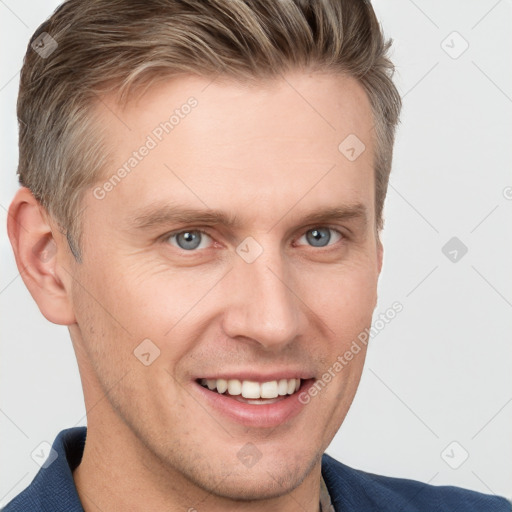 Joyful white young-adult male with short  brown hair and grey eyes