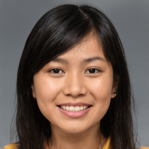 Joyful asian young-adult female with long  brown hair and brown eyes