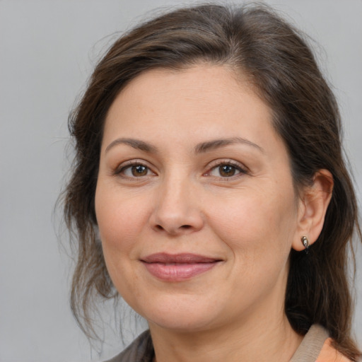 Joyful white adult female with medium  brown hair and brown eyes