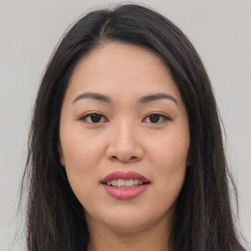 Joyful asian young-adult female with long  brown hair and brown eyes