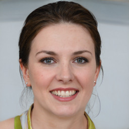 Joyful white young-adult female with medium  brown hair and blue eyes