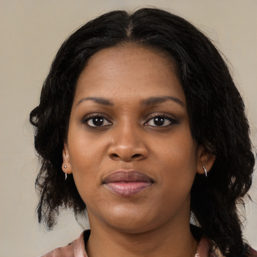 Joyful black young-adult female with medium  black hair and brown eyes