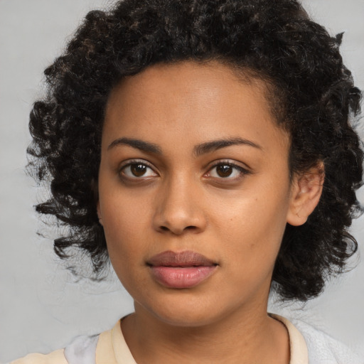 Joyful black young-adult female with medium  brown hair and brown eyes
