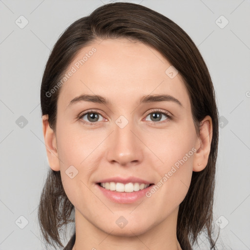 Joyful white young-adult female with medium  brown hair and grey eyes