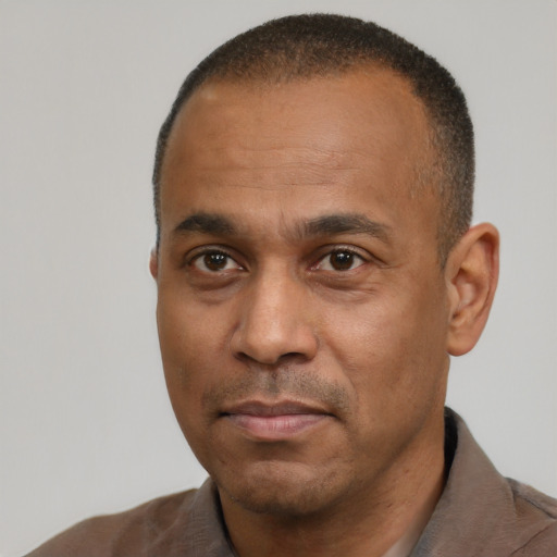 Neutral latino adult male with short  black hair and brown eyes