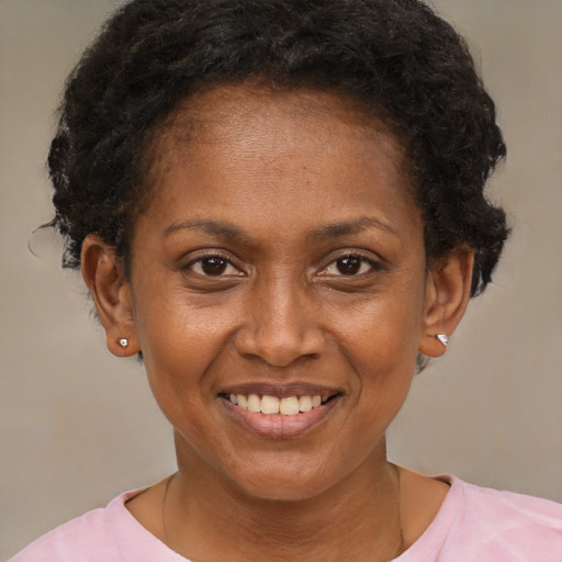 Joyful black adult female with short  brown hair and brown eyes