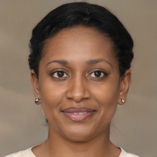 Joyful black young-adult female with short  brown hair and brown eyes
