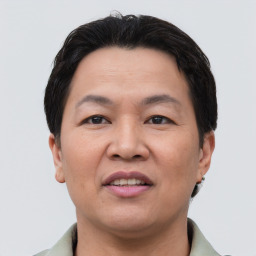 Joyful asian adult male with short  brown hair and brown eyes