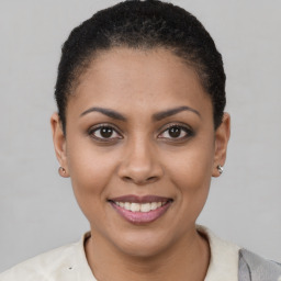 Joyful latino young-adult female with short  brown hair and brown eyes