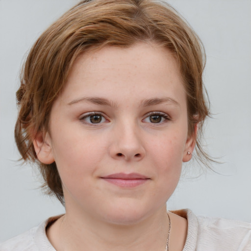 Joyful white child female with medium  brown hair and blue eyes