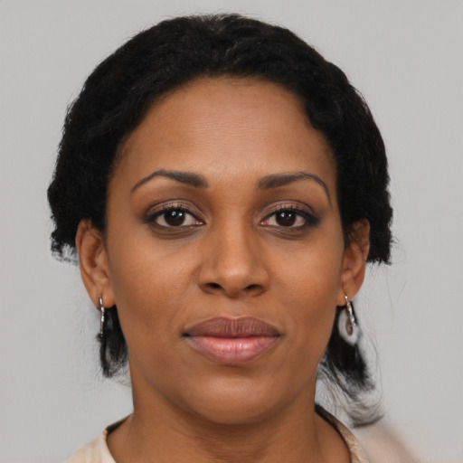 Joyful black young-adult female with medium  black hair and brown eyes