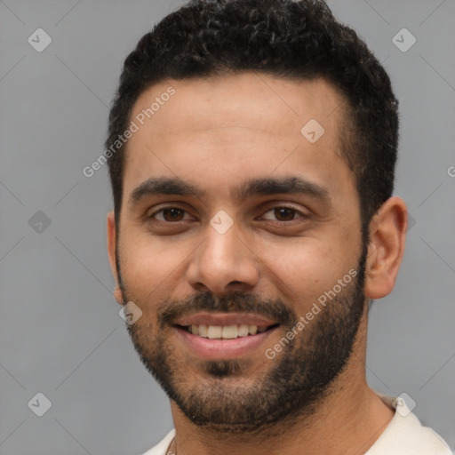 Joyful white young-adult male with short  black hair and brown eyes