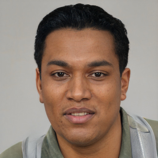 Joyful latino young-adult male with short  black hair and brown eyes