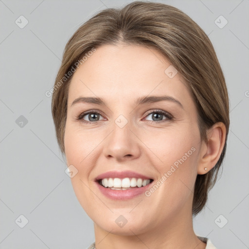 Joyful white young-adult female with medium  brown hair and grey eyes