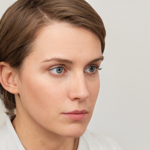 Neutral white young-adult female with medium  brown hair and grey eyes