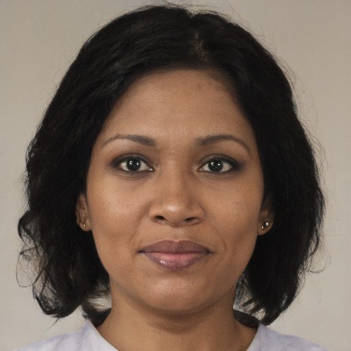 Joyful black adult female with medium  black hair and brown eyes