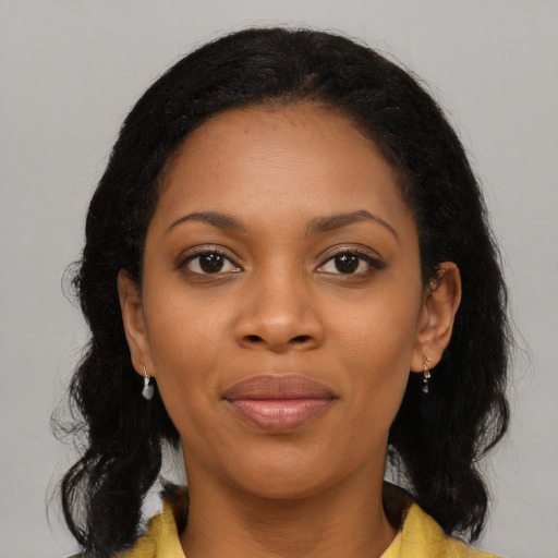 Joyful black young-adult female with medium  brown hair and brown eyes