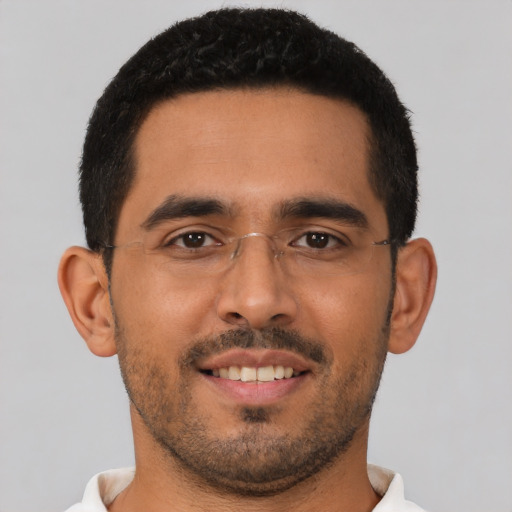 Joyful latino young-adult male with short  brown hair and brown eyes