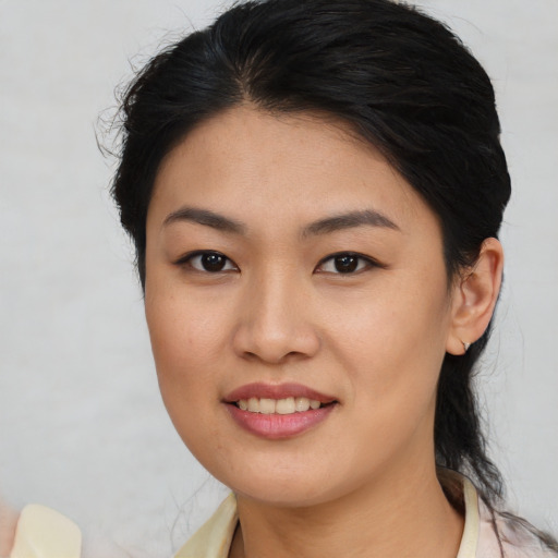 Joyful asian young-adult female with medium  brown hair and brown eyes