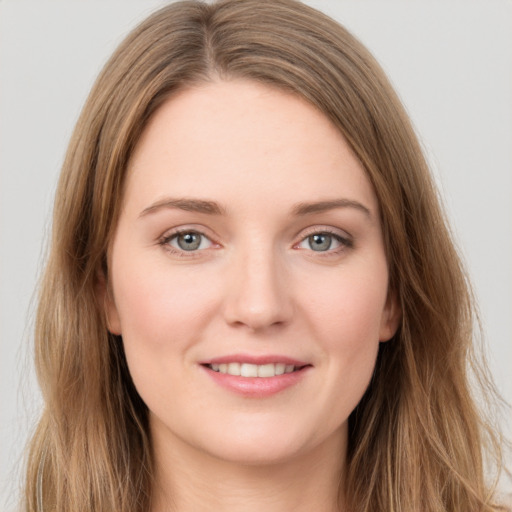 Joyful white young-adult female with long  brown hair and grey eyes