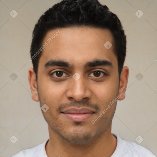 Joyful latino young-adult male with short  black hair and brown eyes