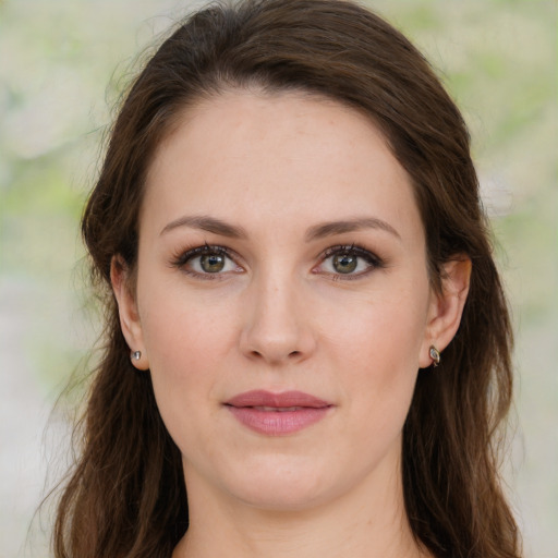 Joyful white young-adult female with medium  brown hair and green eyes