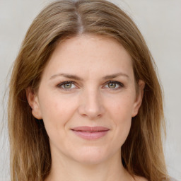 Joyful white young-adult female with long  brown hair and green eyes