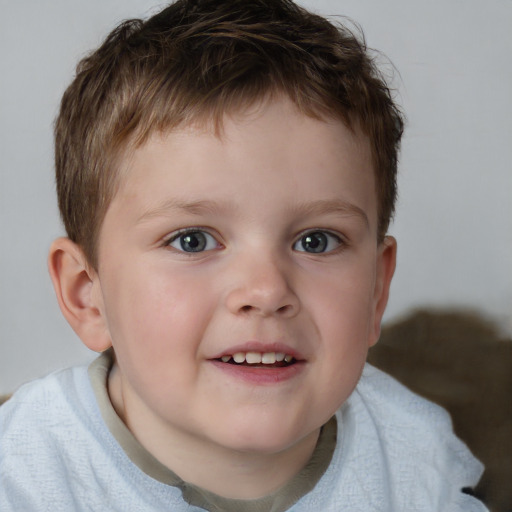 Joyful white child male with short  brown hair and blue eyes