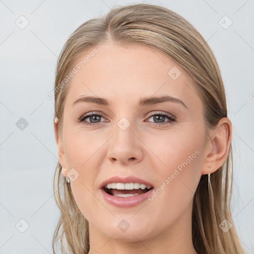 Joyful white young-adult female with long  brown hair and grey eyes