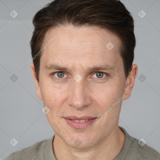 Joyful white adult male with short  brown hair and grey eyes